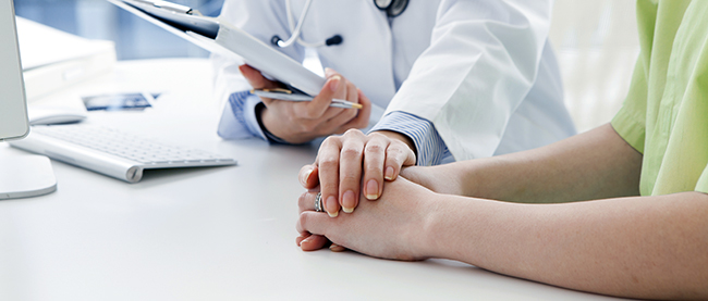 Atencin personalizada: doctora dndole la mano a paciente.